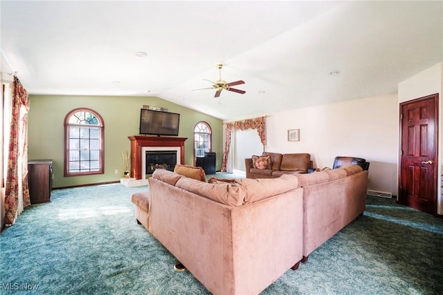 living area with carpet floors, ceiling fan, vaulted ceiling, and plenty of natural light