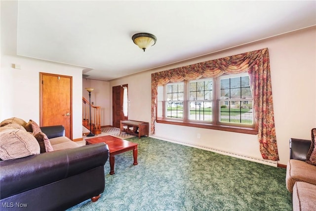 carpeted living room featuring stairway and baseboards