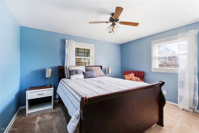 bedroom featuring baseboards, carpet flooring, and a ceiling fan
