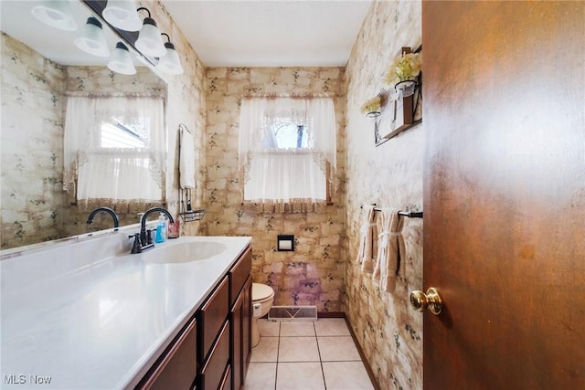 bathroom with toilet, visible vents, tile patterned flooring, and vanity