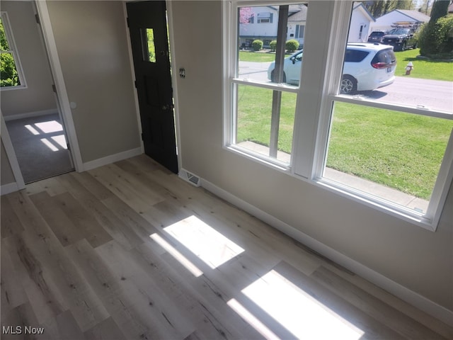 entryway featuring baseboards and wood finished floors