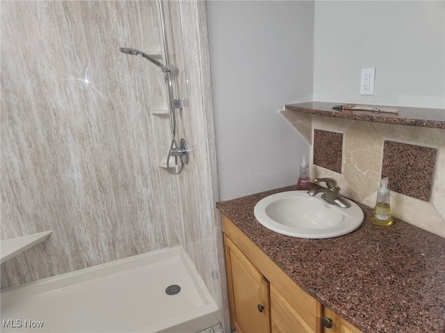 bathroom with vanity and a shower stall