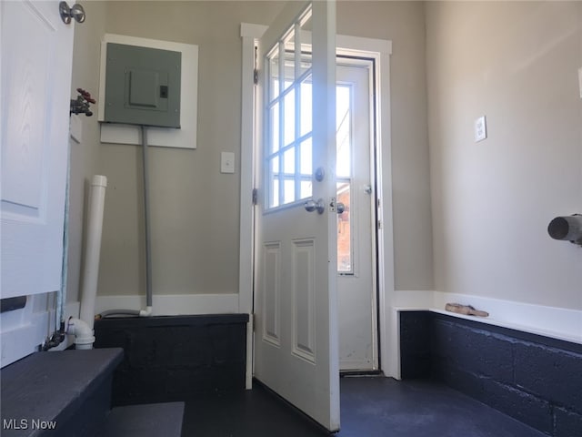 doorway with finished concrete floors and electric panel