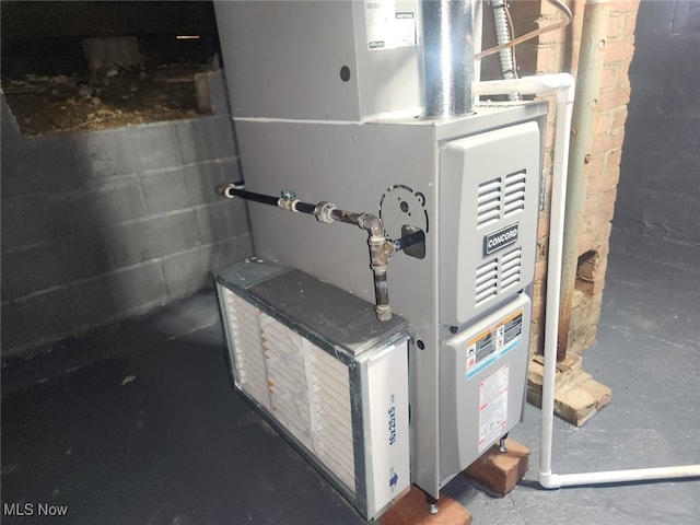 utility room featuring heating unit