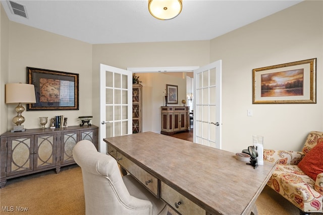 carpeted office space featuring visible vents and french doors