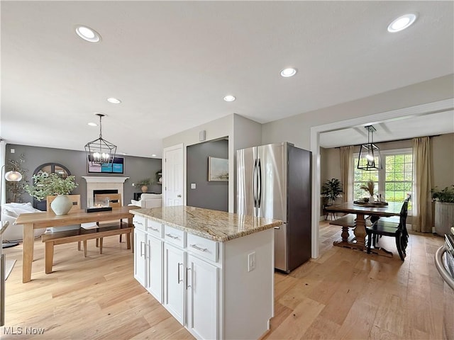 kitchen featuring freestanding refrigerator, white cabinetry, recessed lighting, and light wood-style floors