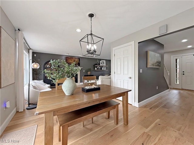 dining area with recessed lighting, baseboards, a notable chandelier, and light wood-style floors