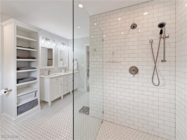 full bathroom featuring vanity, a walk in shower, and tile patterned floors
