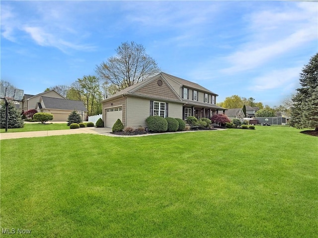 view of front of home with a garage, concrete driveway, and a front yard