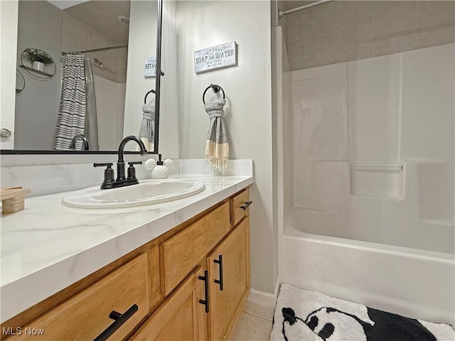 bathroom with tile patterned floors, shower / tub combo with curtain, and vanity