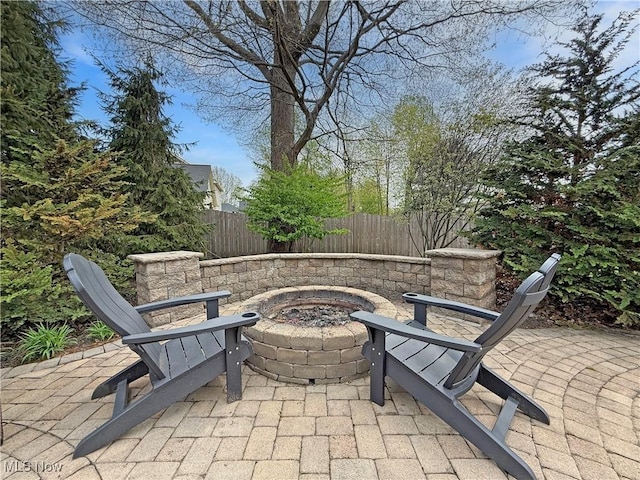 view of patio with fence and an outdoor fire pit