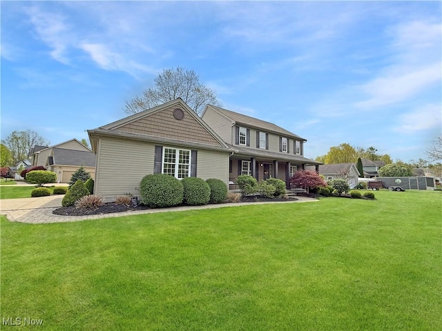 traditional-style home featuring a front lawn