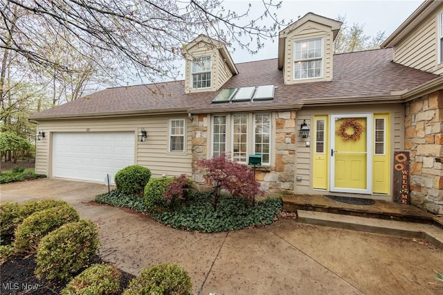 117 Royal Oak Dr, Aurora, OH 44202 - view of front of house featuring a garage, a shingled roof, concrete driveway, and stone siding