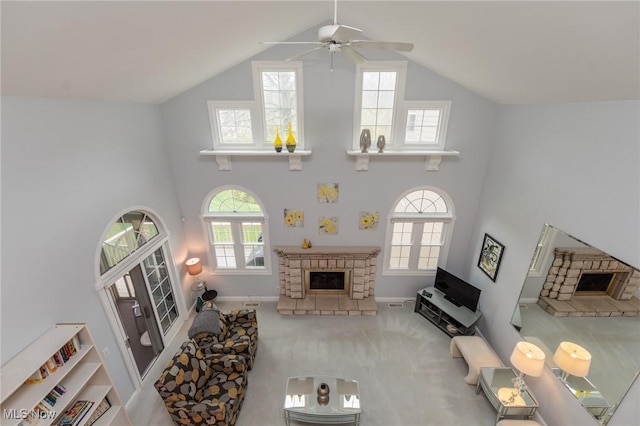 117 Royal Oak Dr, Aurora, OH 44202 - living room with a healthy amount of sunlight, high vaulted ceiling, a fireplace, and a ceiling fan
