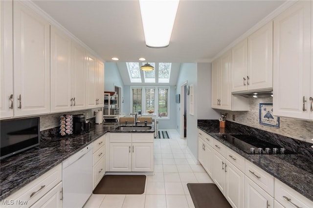 117 Royal Oak Dr, Aurora, OH 44202 - kitchen with white dishwasher, light tile patterned floors, a sink, and tasteful backsplash