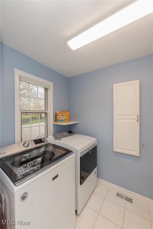 117 Royal Oak Dr, Aurora, OH 44202 - clothes washing area with light tile patterned flooring, laundry area, baseboards, visible vents, and washing machine and dryer