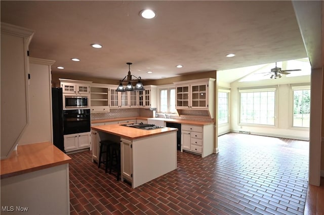 kitchen with wooden counters, recessed lighting, white cabinets, backsplash, and black appliances
