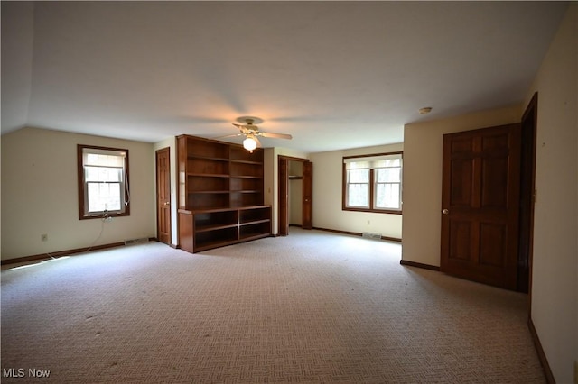 unfurnished living room with a ceiling fan, baseboards, light colored carpet, and visible vents