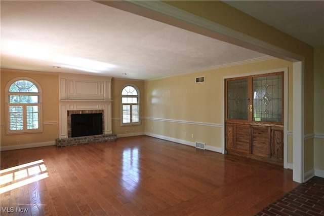 unfurnished living room with crown molding, baseboards, and visible vents