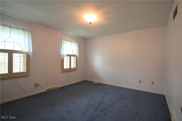 unfurnished room featuring visible vents, carpet flooring, and baseboards