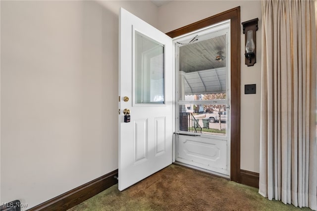 doorway with baseboards and dark colored carpet