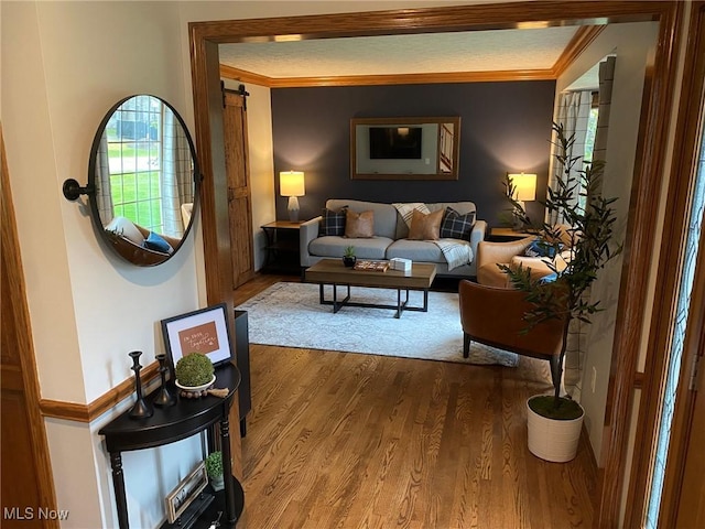 living area featuring crown molding and wood finished floors