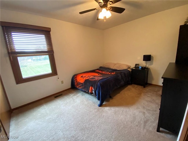 bedroom with baseboards, carpet, a ceiling fan, and visible vents