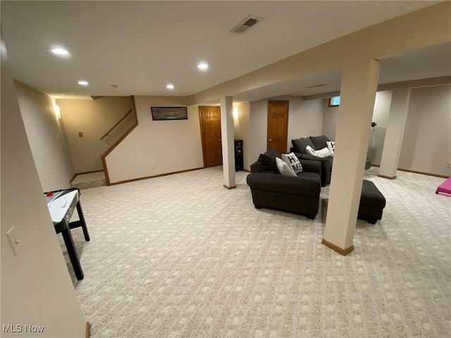 finished basement with visible vents, recessed lighting, and light colored carpet