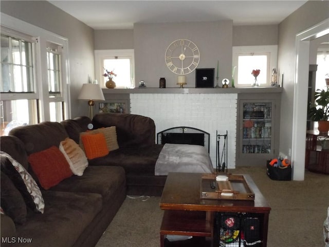 carpeted living room featuring a fireplace