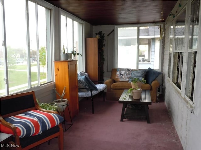 sunroom / solarium with carpet floors and wood ceiling