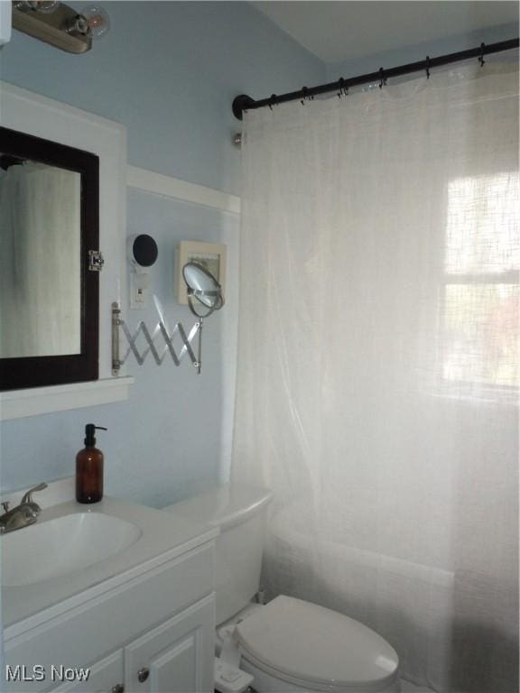 bathroom with vanity, toilet, and a shower with curtain