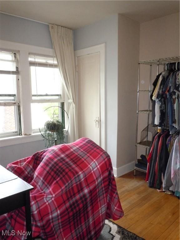 bedroom featuring baseboards and wood finished floors