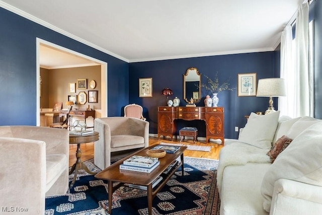 living room with crown molding and wood finished floors