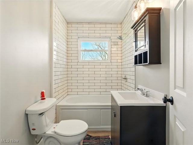 full bathroom featuring vanity, bathing tub / shower combination, and toilet