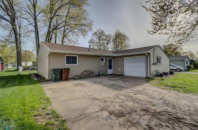 exterior space featuring an attached garage, a yard, and concrete driveway