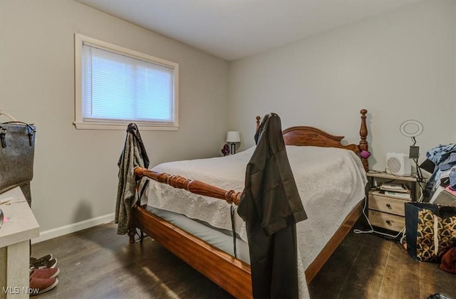 bedroom featuring baseboards and wood finished floors