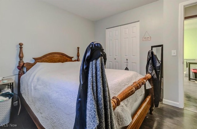 bedroom featuring a closet, baseboards, and wood finished floors