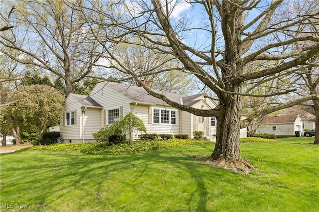 view of front of house with a front yard and a chimney