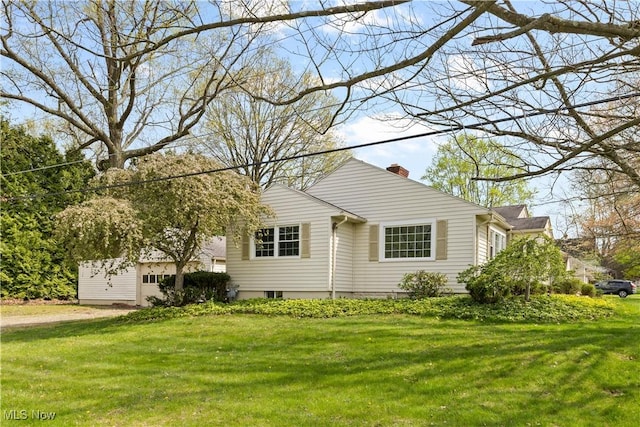 view of front of house with a front yard and a chimney