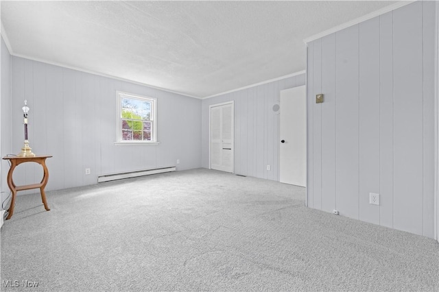 interior space featuring crown molding, a baseboard radiator, carpet flooring, and a textured ceiling