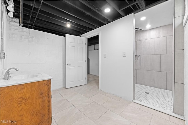 bathroom featuring a walk in shower and vanity