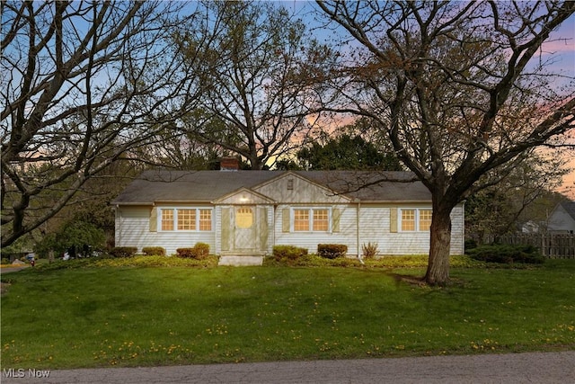 ranch-style house featuring a lawn and a chimney