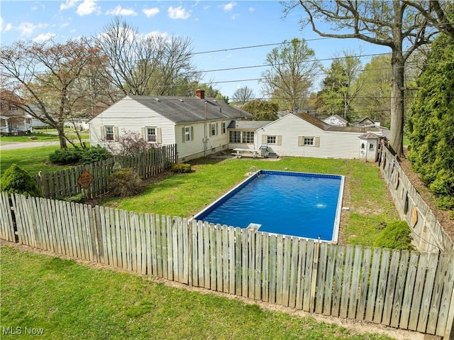 view of pool with a lawn, a fenced backyard, and a fenced in pool