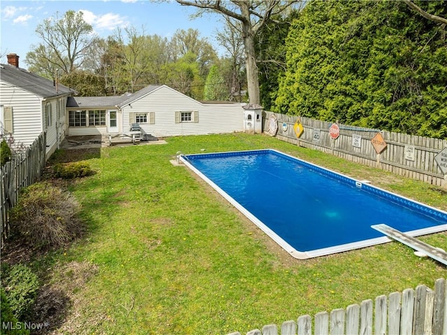 view of pool featuring a fenced in pool, a fenced backyard, a lawn, and a patio area