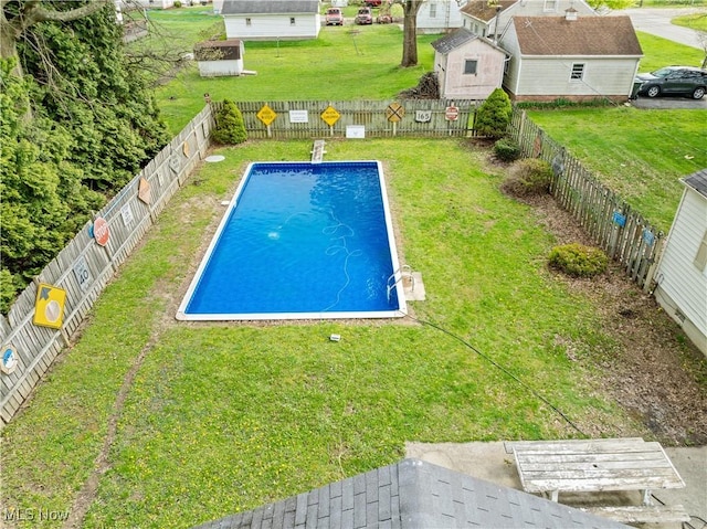 view of swimming pool featuring a fenced in pool, a fenced backyard, and a lawn