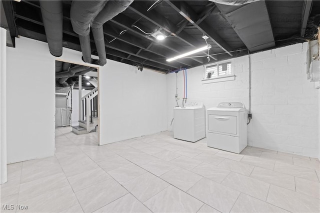 basement featuring stairs and separate washer and dryer