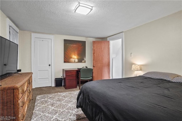 carpeted bedroom featuring a textured ceiling