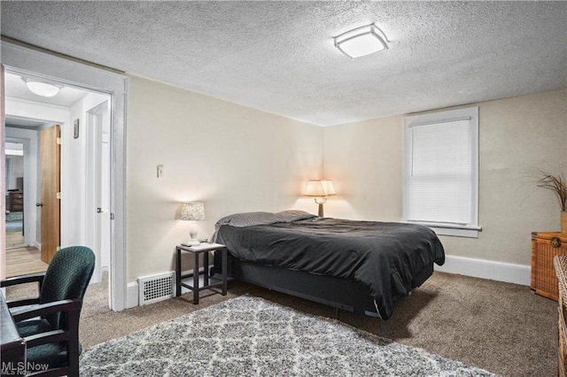 bedroom with baseboards, carpet, a textured ceiling, and visible vents