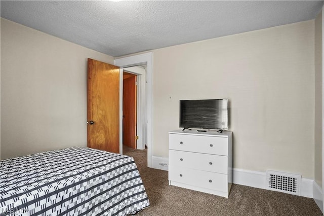 carpeted bedroom with visible vents and a textured ceiling