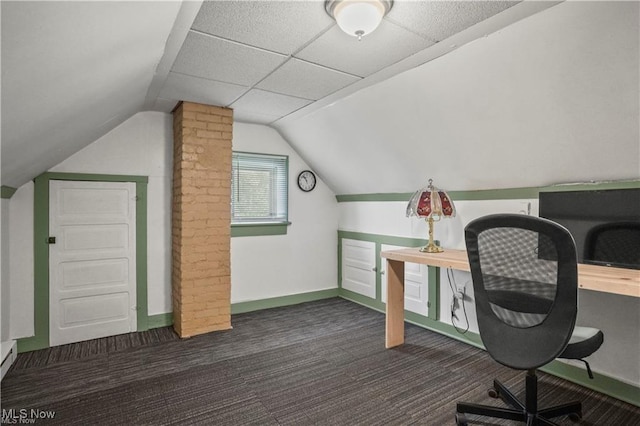 unfurnished office featuring vaulted ceiling, baseboards, and carpet flooring